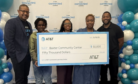 A group of 5 people holding a ceremonial check