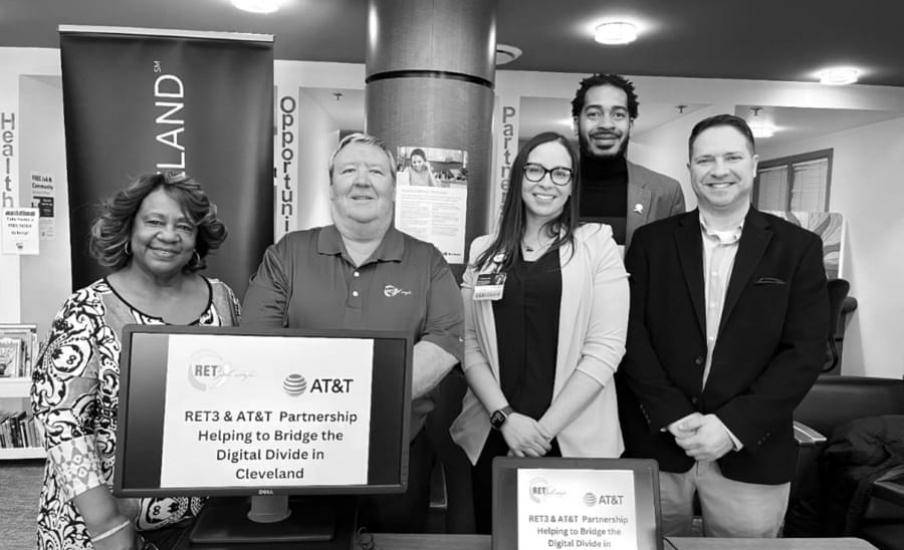 Group of people standing in front of computers