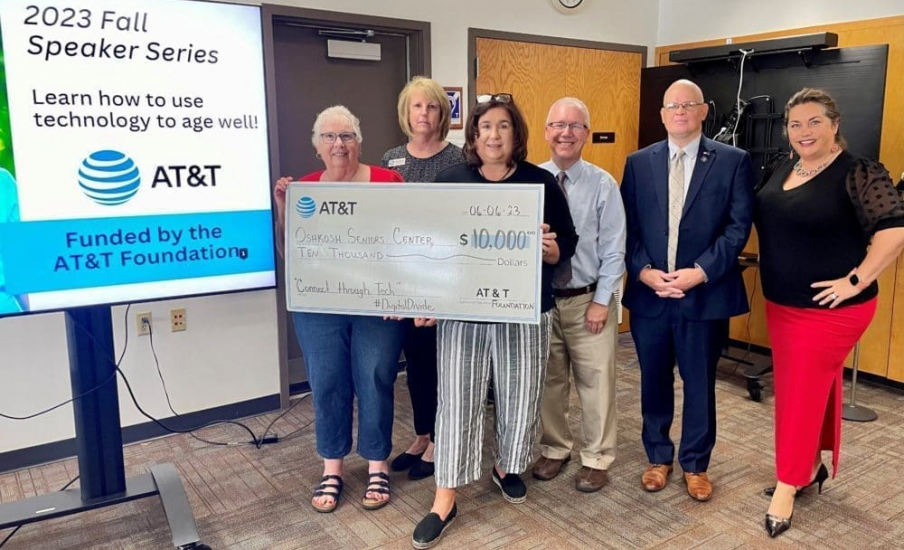 A group of people holding a novelty check