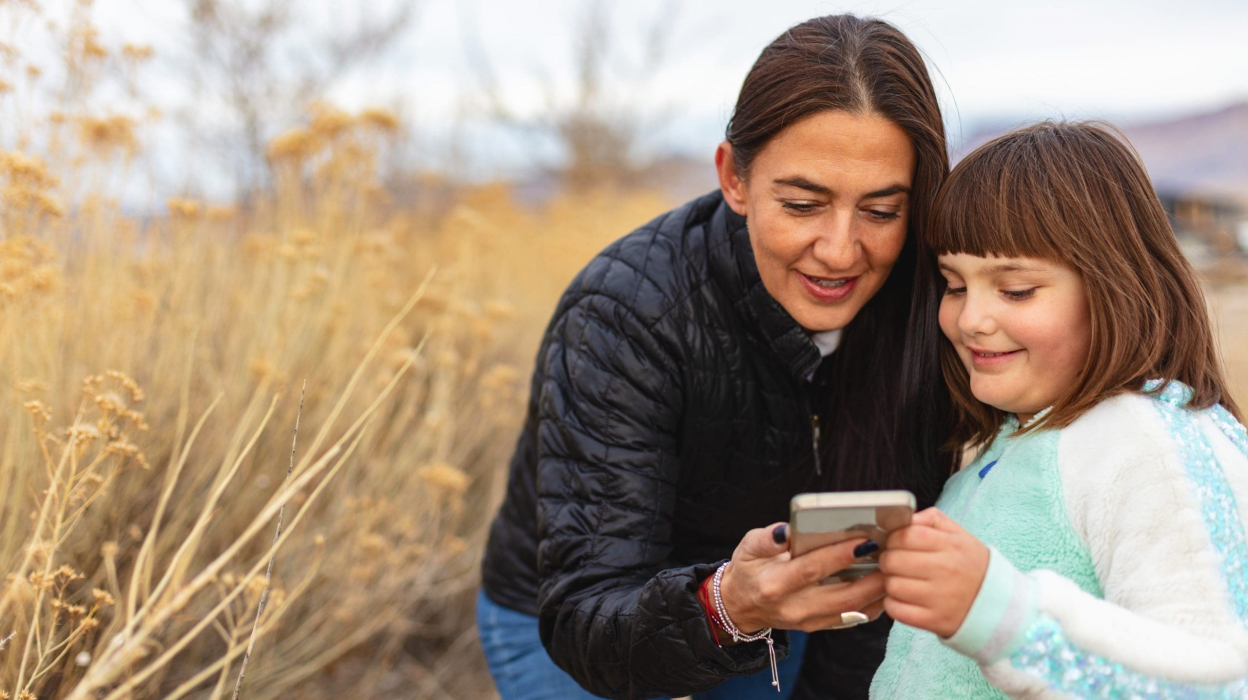 A woman and a child on a phone