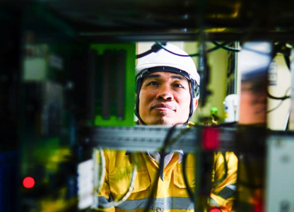 An AT&T tech working on a component.