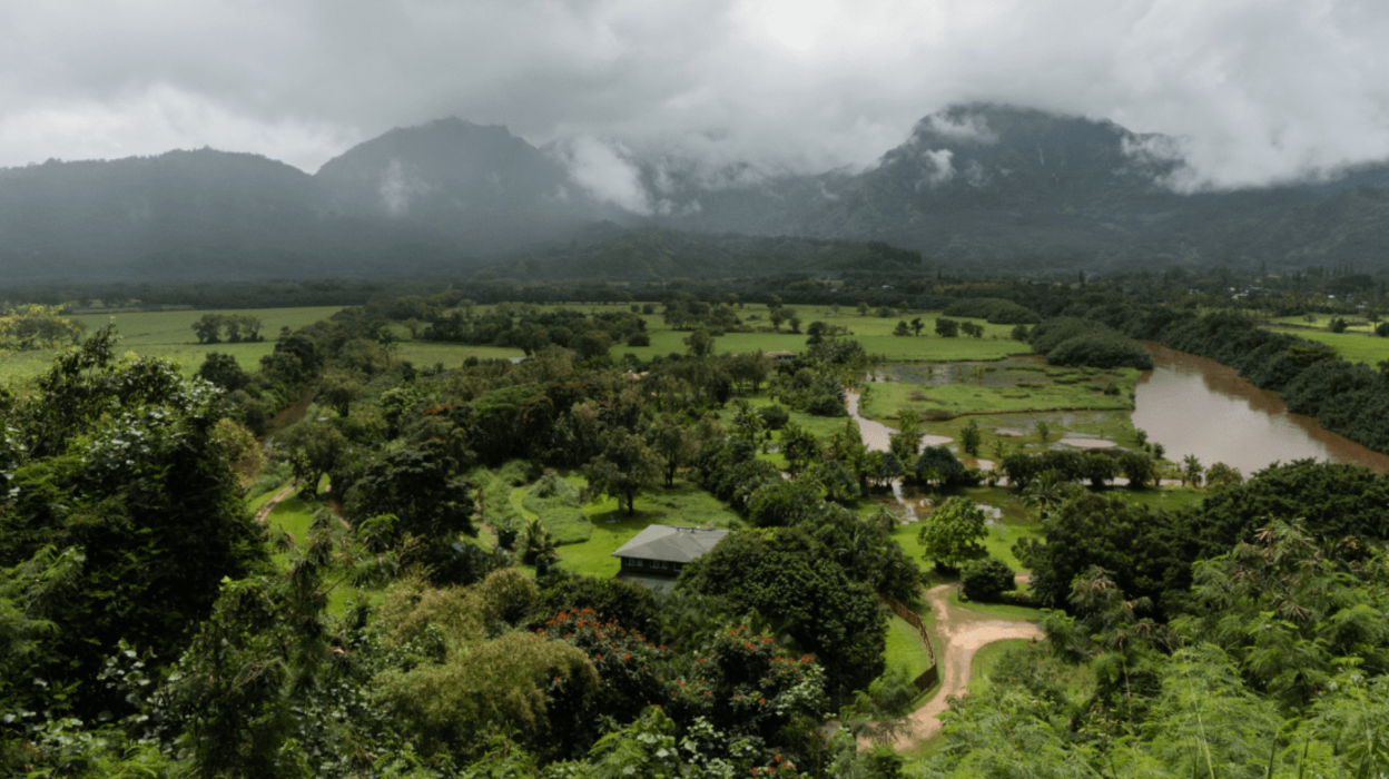 An image of a cloudy mountain overlooking a wet valley