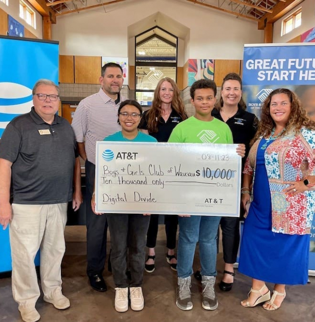 People holding a giant check