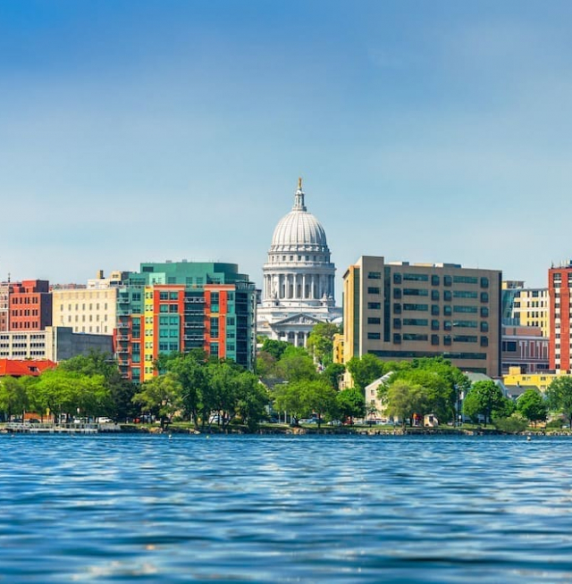 a skyline view of Madison, Wisconsin, taken from across one of its lakes