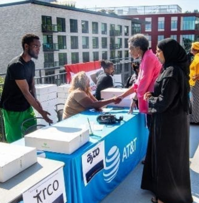 People shaking hands with people at a table