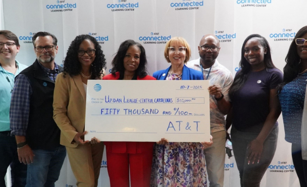 people holding a ceremonial check