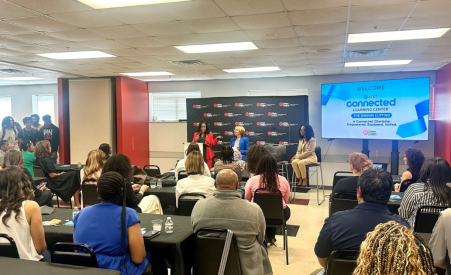 people sitting in a room listening to a speaker